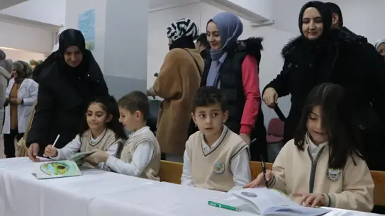 İmza gününde öğrenciler şiir kitabını imzalıyor